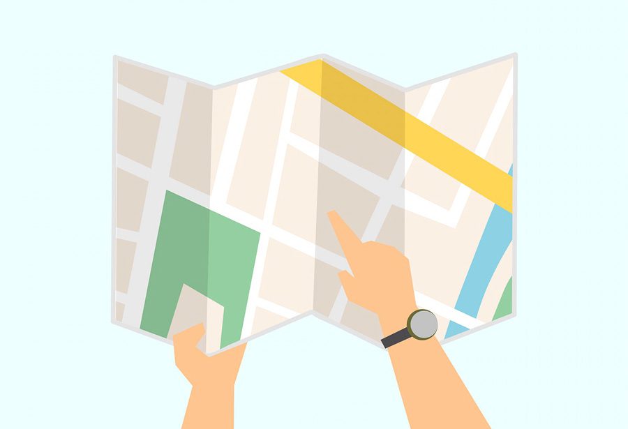 Hands holding and pointing at map